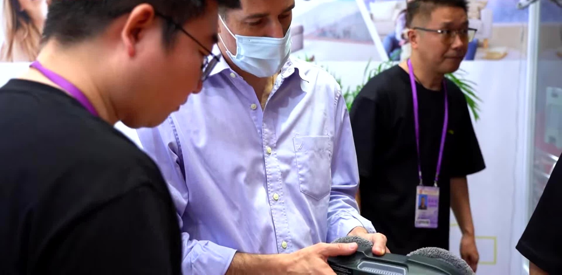 Einkäufer prüfen an einem Stand der Canton Fair in Guangzhou ein Produkt